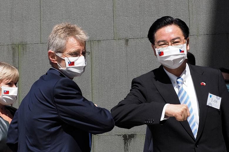 Czech Republic's Senate Speaker Milos Vystrcil (left) exchanging elbow greetings with Taiwan Foreign Minister Joseph Wu at National Chengchi University in Taipei yesterday.