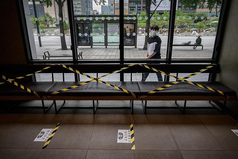 A taped-off seating area at a Seoul cafe yesterday. The health authorities have focused efforts on discouraging social gatherings of people aged between 20 and 40, who accounted for nearly 40 per cent of confirmed Covid-19 cases last week. This has l