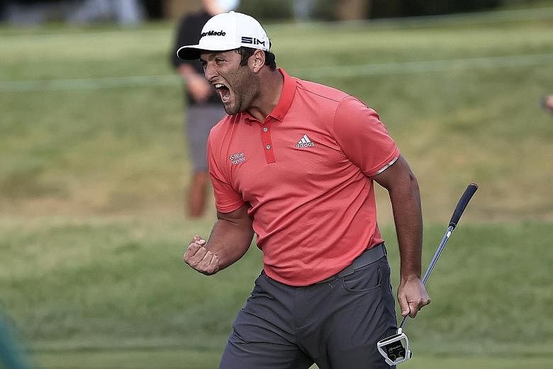 Jon Rahm screaming in delight after sinking a 66-foot putt to edge out world No. 1 Dustin Johnson at the first play-off hole of the BMW Championship on Sunday. It was his second win of the season and fifth overall. PHOTO: EPA-EFE