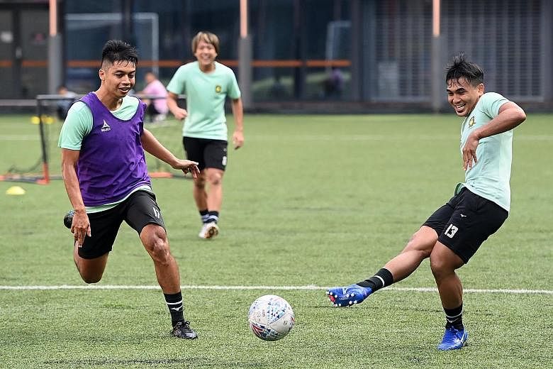 Tampines forward Taufik Suparno (right) and defender Irwan Shah having fun during training. The SPL leaders were the first team to return to training when Singapore moved to phase two of post-circuit breaker measures in June. PHOTO: FACEBOOK/ TAMPINE