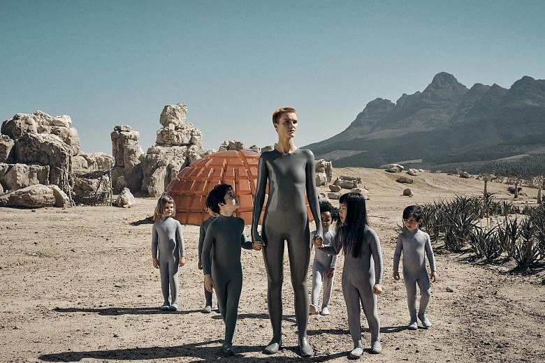 Science-fiction series Raised By Wolves, directed by Ridley Scott (above), stars Amanda Collin (left, centre) as an android raising human children on an inhospitable planet.