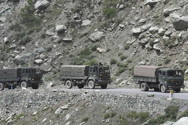 Indian army vehicles on the highway leading to Ladakh yesterday, following renewed tensions between India and China at the Line of Actual Control in the western Himalayan region. PHOTO: EPA-EFE A mural in New Delhi depicting the Indian soldiers kille
