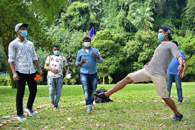 Foreign workers enjoying a game at Labrador Park yesterday afternoon. They were among some 50 workers chosen to go on the outing by the Ministry of Manpower, which had collaborated with the Alliance of Guest Workers Outreach to organise the excursion