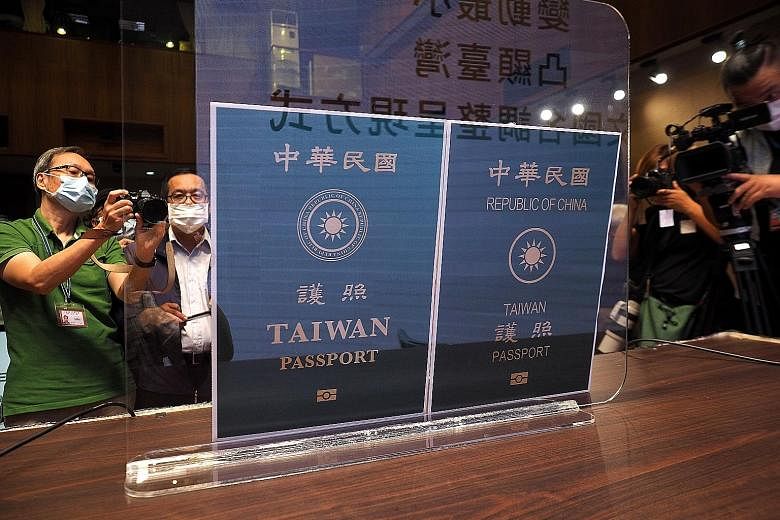 Photocopies of the covers of the new Taiwan passport (left) and the current one, at the unveiling in Taipei yesterday. Passports issued starting from January next year will sport the new look. PHOTO: EPA-EFE