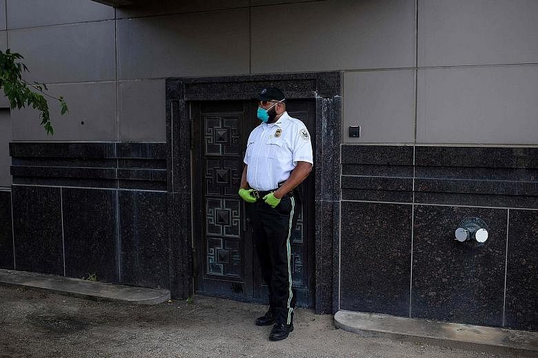 A United States law enforcement officer standing guard at a back door of the Chinese consulate in Houston in July, after the Trump administration ordered it to be closed. PHOTO: AGENCE FRANCE-PRESSE