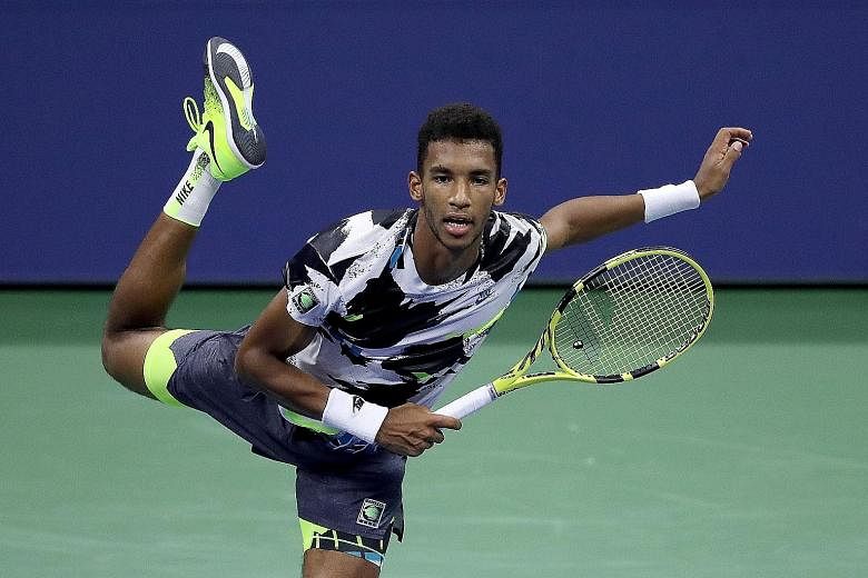 Above: Felix Auger-Aliassime serving during his second-round match against Britain's Andy Murray. The Canadian smashed 24 aces and 52 winners in a 6-2, 6-3, 6-4 victory. Left: Murray could muster only two aces and nine winners. PHOTOS: AGENCE FRANCE-
