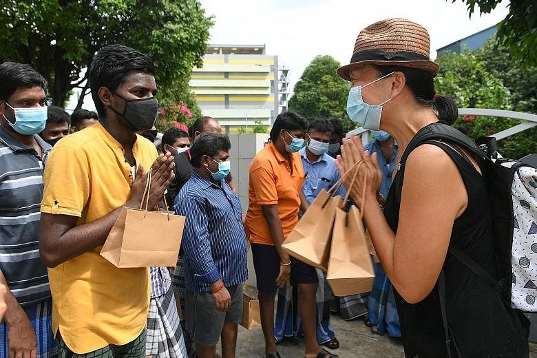 Former Nominated MP Anthea Ong giving self-care kits to migrant workers in July. The pandemic has led Singaporeans to be more appreciative of foreign and front-line workers, says Senior Minister of State Sim Ann. ST PHOTO: SHINTARO TAY
