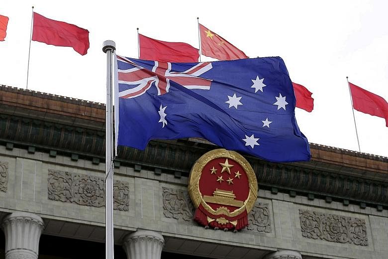 A 2016 file photo showing the Australian flag in front of the Great Hall of the People in Beijing during a welcoming ceremony for Australia's then Prime Minister Malcolm Turnbull. Trade with China remains vital to Australia, which has a US$172 billio