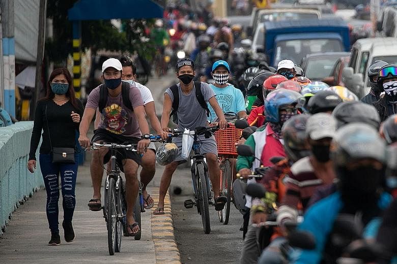 Cyclists taking to a sidewalk in Metro Manila last month as traffic built up at a checkpoint on the first day of the Philippine government's reimplementation of a stricter lockdown to curb the coronavirus outbreak.