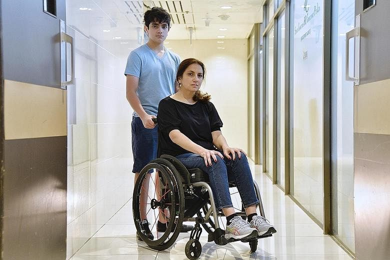 Ms Valencia Zuniga, seen here with her youngest child Emilio Klenner, 14, uses a wheelchair as a result of an alleged botched operation.