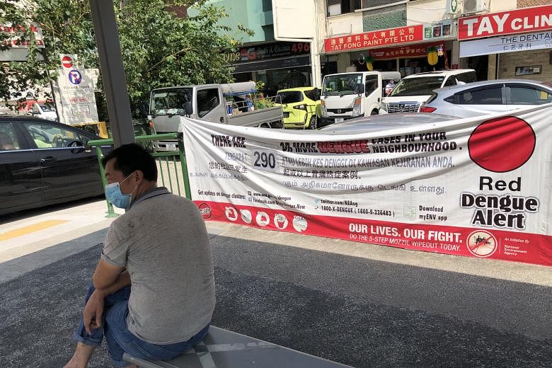 A red alert dengue banner at a bus stop in Geylang Road early last month. It is important for people with dengue to prevent themselves from being bitten again while they remain infectious. Even someone who has been bitten but has no symptoms can stil