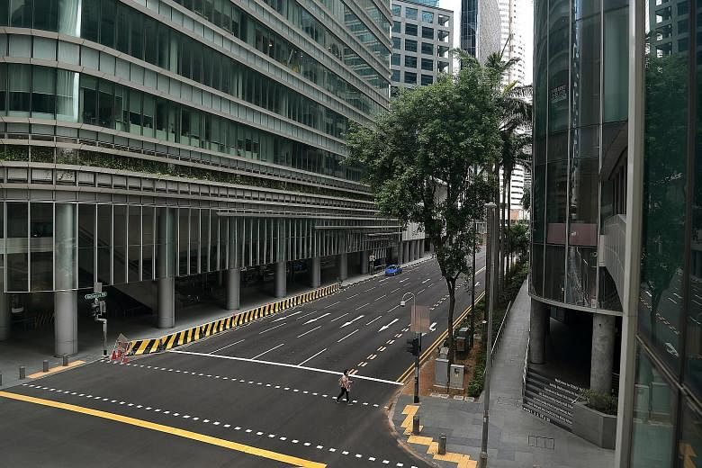 An almost deserted Robinson Road during Singapore's circuit breaker period in April. A DBS report notes that the second-quarter results season had reflected the impact of global Covid-19 lockdowns, with a sharp 14.9 per cent cut in forecast earnings 