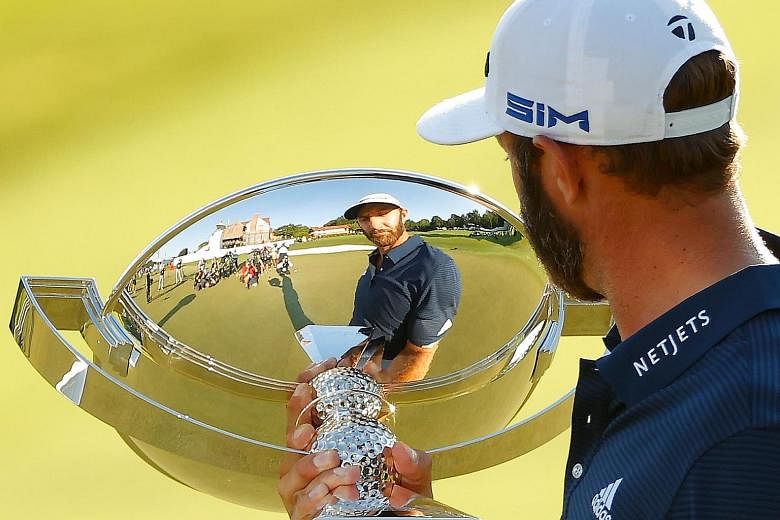 World No. 1 Dustin Johnson admiring the elusive FedExCup trophy after winning the Tour Championship by three shots on Monday. PHOTO: AGENCE FRANCE-PRESSE