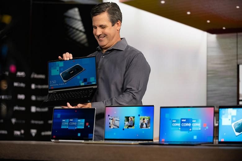 Mr Chris Walker, Intel's vice-president and general manager of Mobile Client Platforms, showing off new Intel Evo laptops from major PC brands.