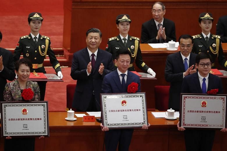 Chinese President Xi Jinping and Premier Li Keqiang (both middle row) clapping as the country bestowed honours on the people who contributed to the fight against the coronavirus. More than 2,000 people were given awards at a ceremony held at the Grea