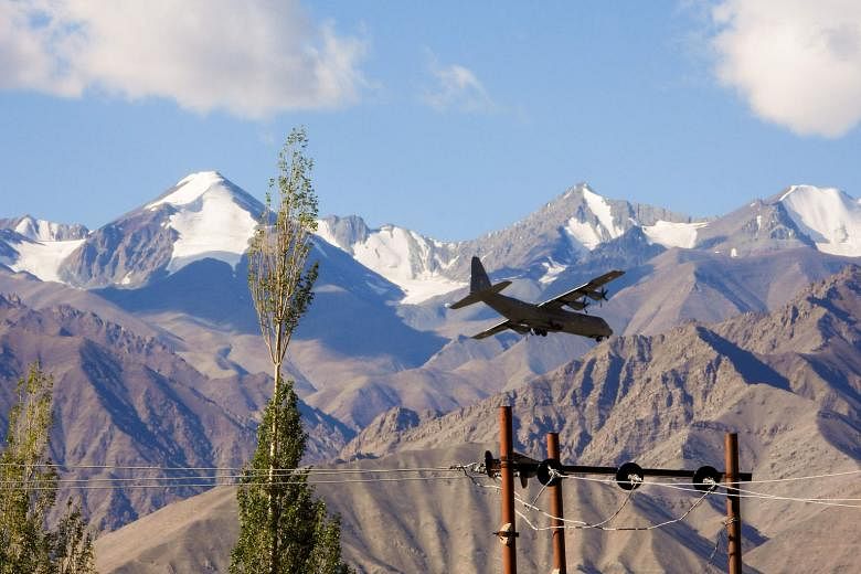 An Indian Air Force Hercules military transport plane preparing to land at an airbase in Leh, the joint capital of the union territory of Ladakh bordering China, yesterday. Hundreds of Indian and Chinese troops are in eyeball-to-eyeball proximity alo