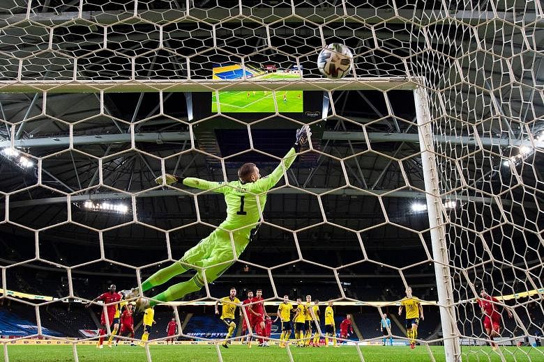 Sweden goalkeeper Robin Olsen grasping at thin air as Portugal forward Cristiano Ronaldo's strike finds the top corner of the goal. PHOTO: AGENCE FRANCE-PRESSE