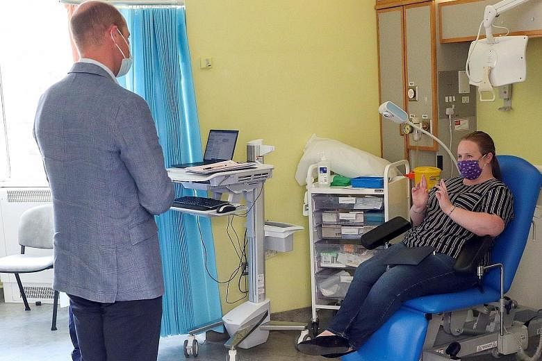 Britain's Prince William talking to a patient participating in a Covid-19 vaccine trial during a visit to the Oxford Vaccine Group's facility at Churchill Hospital in Oxford in June. British drugmaker AstraZeneca's vaccine, which the company is devel