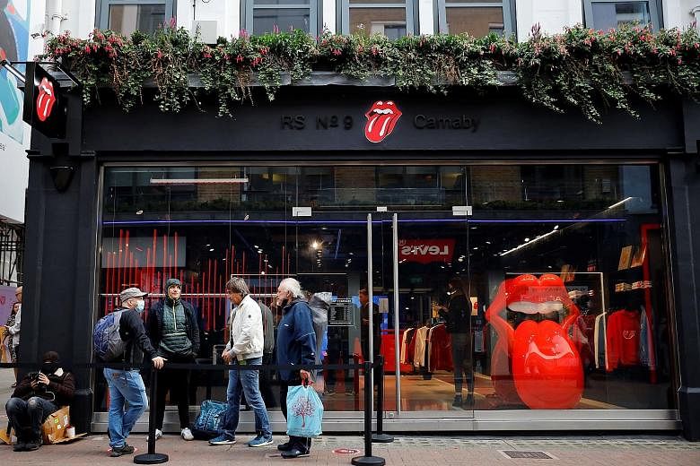 People queueing to enter The Rolling Stones' London store on opening day.