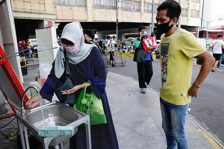A visitor washing her hands before entering a shopping mall in Jakarta yesterday. Java, where Jakarta is located, accounts for 57 per cent of all infections in the country. The Jakarta government has come under fire for a lack of enforcement against 