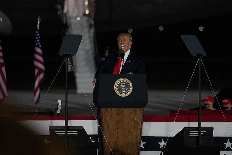 President Donald Trump at a campaign rally in Michigan on Thursday. His bid to focus his re-election campaign on anything but the coronavirus crisis has hit another setback with the revelation in a new book - Rage - that he had knowingly downplayed i