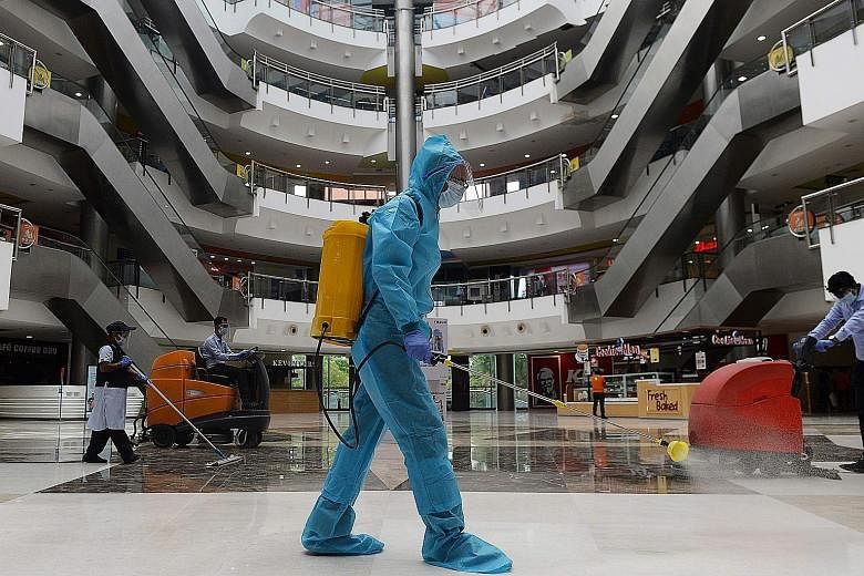 A worker sanitising the floor of a shopping mall in Chennai last week. Even as India has eased restrictions in a bid to protect and expand the economy, a business turnaround has not come because of rising numbers of coronavirus cases. PHOTO: AGENCE F