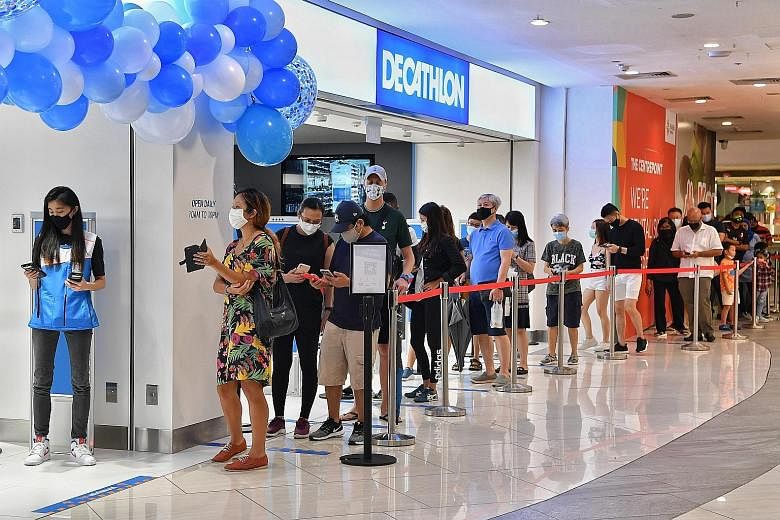 A long queue forming outside Decathlon's new outlet at The Centrepoint, its fifth experience store here. Over 50 people were waiting for the official opening yesterday morning.