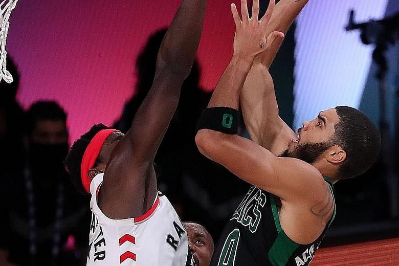 Boston's Jayson Tatum going for a shot as Toronto's Pascal Siakam defends in Game Seven of their Eastern Conference semi-finals in Lake Buena Vista, Florida. Boston eliminated the champions and are aiming to reach the NBA Finals for the first time in