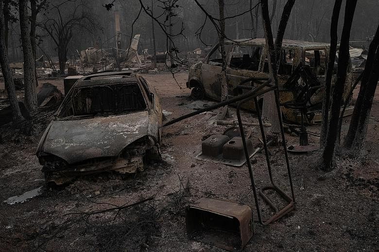 Razed vehicles in the aftermath of a blaze in Eagle Point, Oregon. The firestorms have blanketed the skies over California, Oregon and Washington state with smoke and ash.