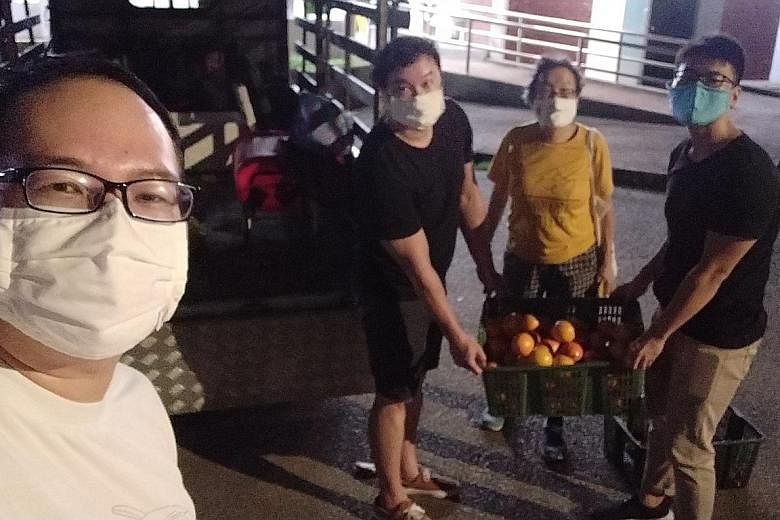 Retired financial adviser Daniel Tay and his friends, freegans who retrieve and reuse discarded items, collecting fruit during the seventh lunar month.
