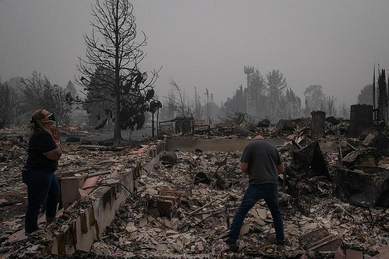 Above: A drone shot of the gutted Medford Estates in the aftermath of the Almeda Fire in Medford, Oregon, last Thursday. PHOTO: REUTERS Inmate firefighters with Vallecito Crew 1 heading out to battle the Bear Fire, part of the North Complex Fire, nea