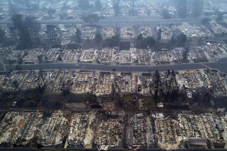 Above: A drone shot of the gutted Medford Estates in the aftermath of the Almeda Fire in Medford, Oregon, last Thursday. PHOTO: REUTERS Inmate firefighters with Vallecito Crew 1 heading out to battle the Bear Fire, part of the North Complex Fire, nea
