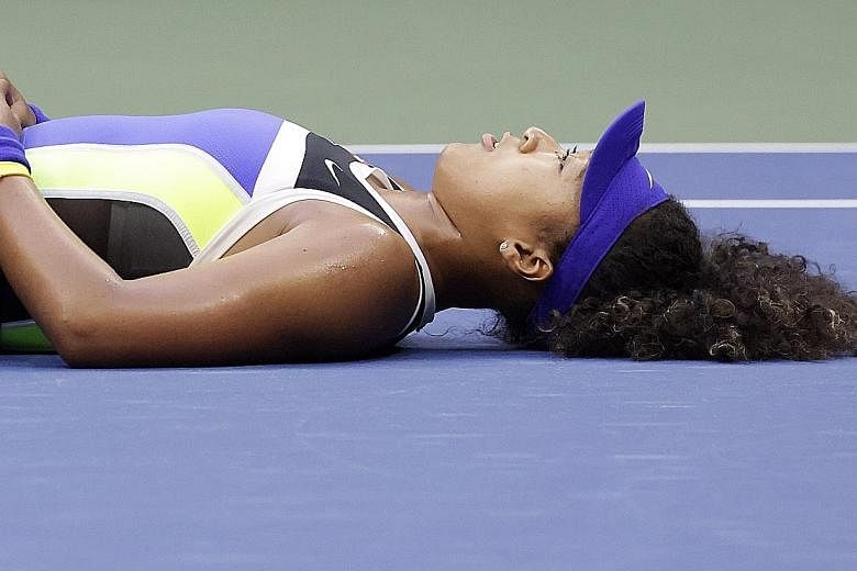 Enjoying a quiet moment after coming from behind to beat Victoria Azarenka for the US Open title on Saturday, Naomi Osaka can be proud that she has successfully channelled her sporting prowess to be a voice for social justice. PHOTO: EPA-EFE