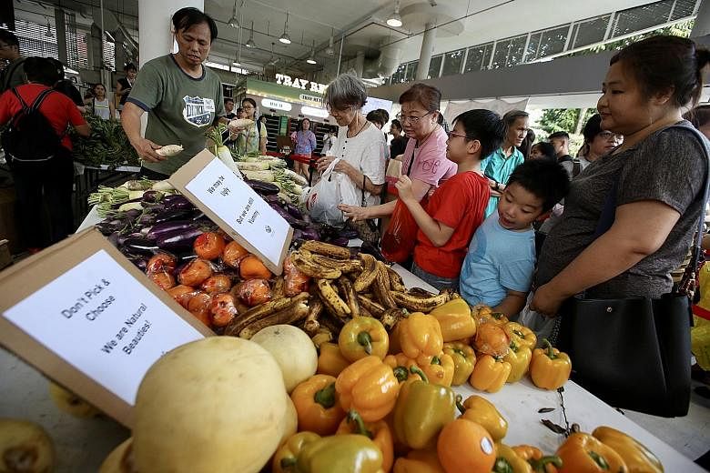 A food wastage awareness drive held by SG Food Rescue at Yishun Park Hawker Centre last year. About 40 per cent of food waste generated in Singapore is estimated to come from commercial and industrial premises such as food manufacturers, caterers, su