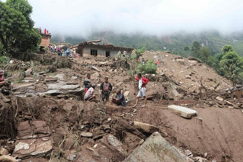Rescue workers searching through the rubble for victims after heavy rain over the weekend slammed the Bahrabise municipality of Sindhupalchok district, about 90km north-east of Kathmandu, Nepal, causing landslides. At least 11 people were killed and 