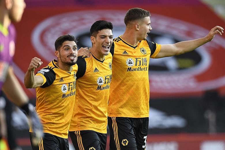 Raul Jimenez (centre) celebrating his opener with teammates. The Mexico striker was Wolves' top scorer in the top flight last season with 17 goals. PHOTO: EPA-EFE