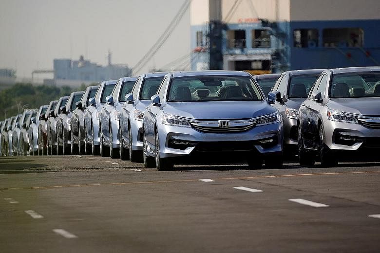 New Honda cars awaiting export at a Yokohama port. The fall in Japan's exports last month was driven by fewer shipments of cars and mineral fuels. PHOTO: REUTERS