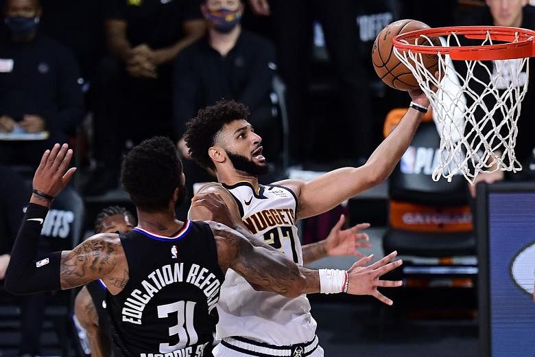 Denver Nuggets guard Jamal Murray scoring two of his game-high 40 points to set up a Western Conference finals match-up with the Los Angeles Lakers. PHOTO: AGENCE FRANCE-PRESSE