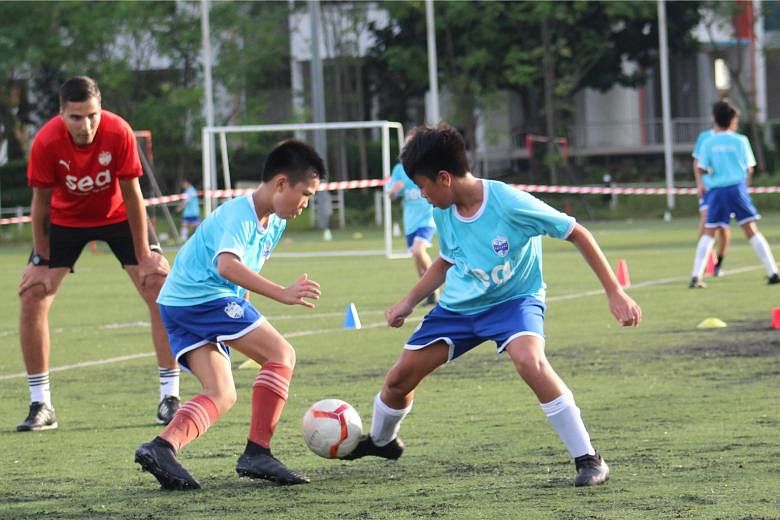 Lion City Sailors Football Academy director Luka Lalic casting a watchful eye on a training session with young players. The club planned to invest over $10 million in a new facility to groom more home-grown talent. PHOTO: LCS FOOTBALL ACADEMY