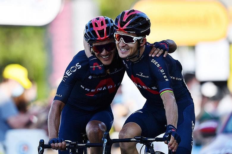 Team Ineos Grenadiers riders Richard Carapaz (left) and Michal Kwiatkowski crossing the finish line of the 18th stage of the Tour de France yesterday. Poland's Kwiatkowski claimed his first ever Grand Tour stage win while giving Ineos Grenadiers thei