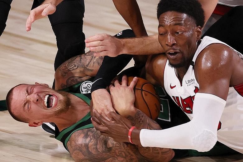 Boston centre Daniel Theis (left) holding on to the ball as Miami forward Bam Adebayo tries to strip it away in Game 2 of the Eastern Conference Finals.