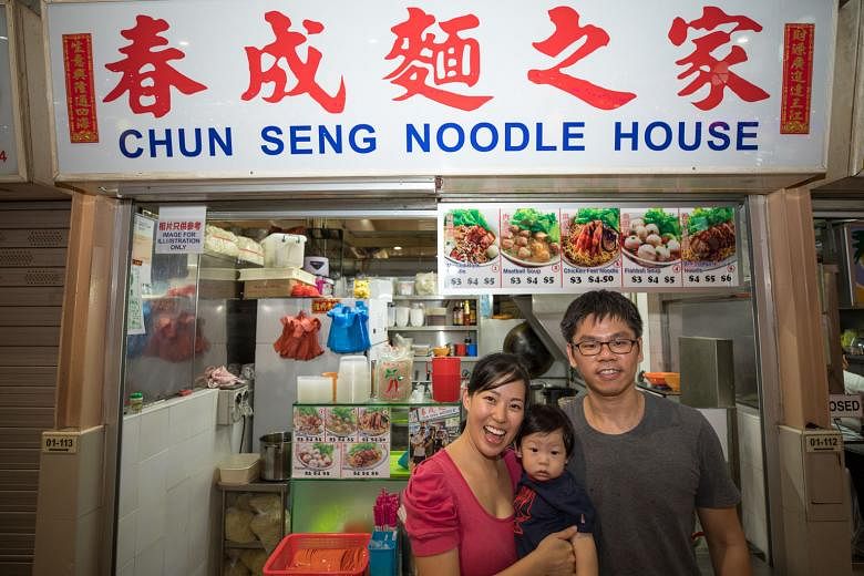 Ms Fiona Lim and Mr Jerry Ng at their bak chor mee stall with their one-year-old son. They have been given an average of 40 per cent rental rebates over 15 months since October last year. PHOTO: NEA