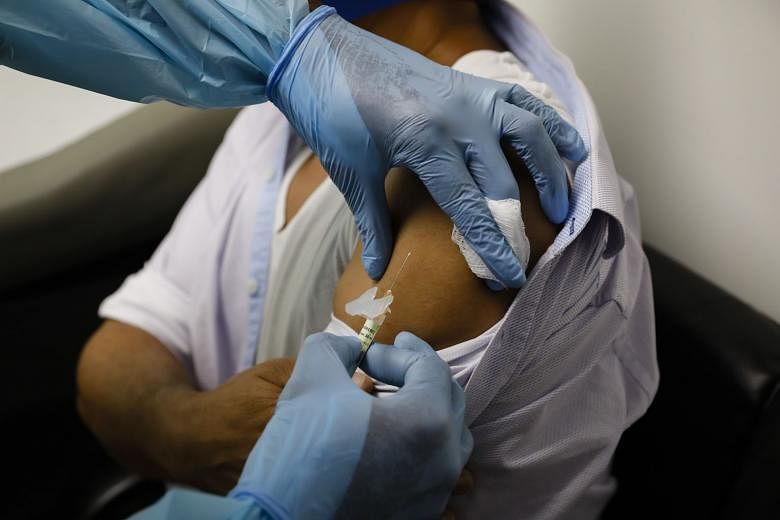 A health worker injecting a person during clinical trials for a Covid-19 vaccine in Hollywood, Florida, earlier this month. Moderna was the first to release its plan ahead of an early Thursday morning investor meeting. PHOTO: BLOOMBERG