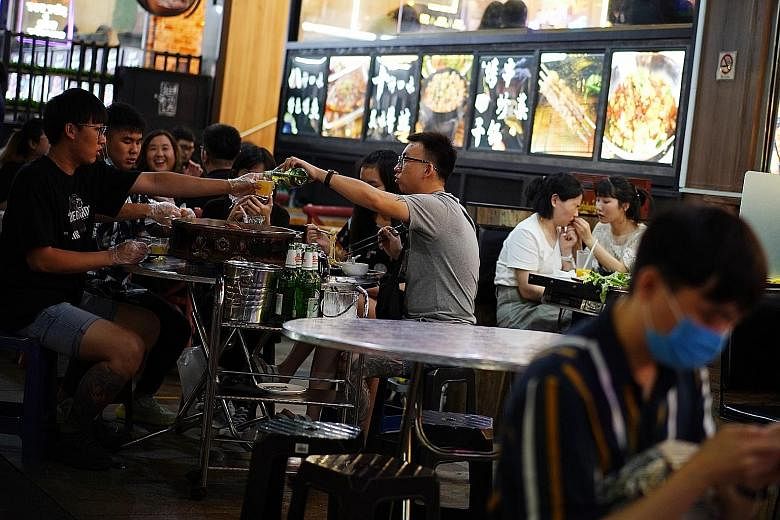 Diners at Bugis Cube's Ming Tang Spicy Roast Fish restaurant in North Bridge Road on Friday. Most operators The Sunday Times spoke to said they either had to reject groups larger than five or split them into separate tables not next to each other.