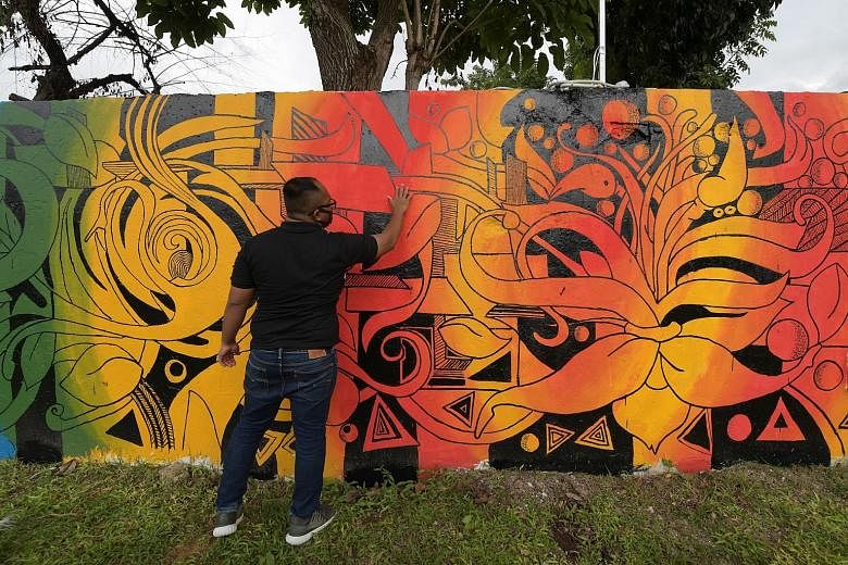 A resident of Jamiyah Halfway House with the mural he helped to design. Mural painting, which is an extension of the halfway house's art therapy programme, is among the new initiatives the centre is using to help former drug addicts stay on the right