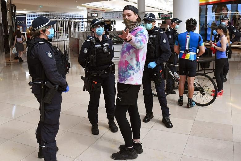 Police stopping people in a Melbourne mall for checks following an anti-lockdown protest on Sunday. Australia reported 16 new coronavirus infections yesterday, its smallest daily increase in cases since mid-June. The bulk of the new cases once again 