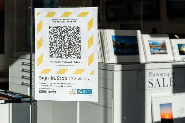 A sign outside a New Zealand shop reminding people to download a QR code for the country's Covid-19 tracing app.