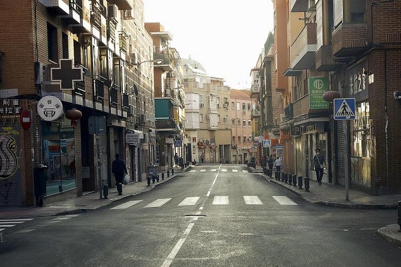A quiet street yesterday in Madrid's Usera district, one of the areas under partial lockdown. Spain's recent spike in infections, peaking at over 10,000 a day, took its total to above 670,000, the highest in Western Europe.