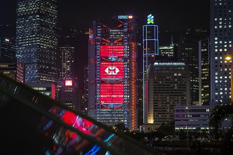 The HSBC and Standard Chartered buildings in Hong Kong. The two banks were among some 90 lenders named in leaked documents that shed light on potentially dubious money transfers worth about US$2 trillion (S$2.7 trillion) between 1999 and 2017. PHOTO: