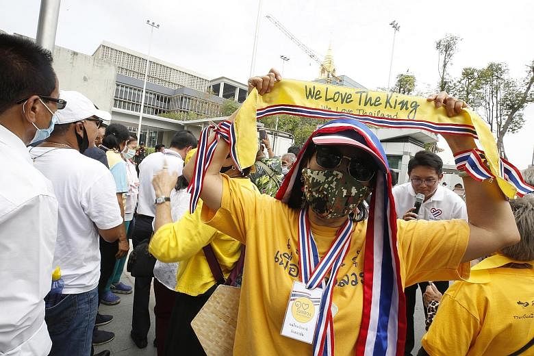 A Thai royalist and pro-government supporter showing support for King Maha Vajiralongkorn during a rally to oppose any amendments to the Constitution outside Parliament House in Bangkok yesterday.